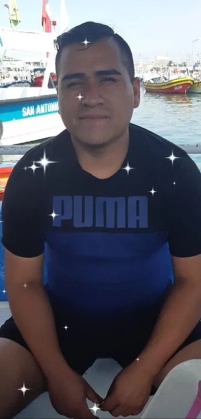 Man seated on boat at a colorful harbor with vibrant boats and clear sky.