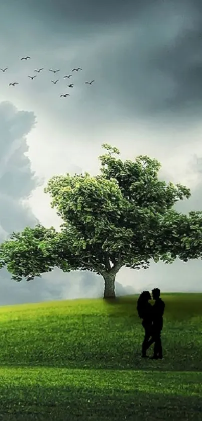 Romantic couple beneath a lush green tree against a cloudy sky.