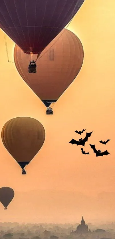 Hot air balloons and bats in an orange sky.