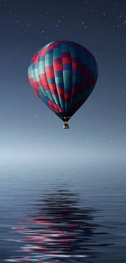 Hot air balloon over calm waters with starry night reflection.