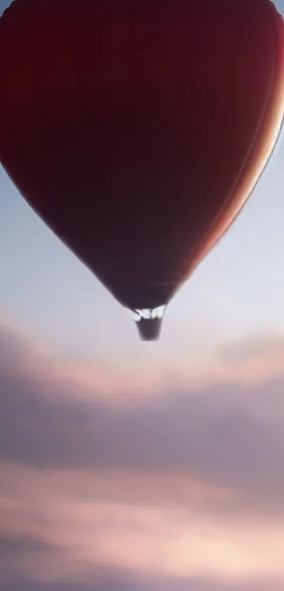Red hot air balloon against a serene sunset sky.