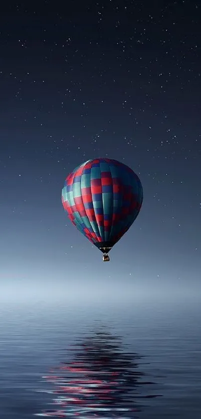 Hot air balloon reflecting over a calm night sea under starry sky.