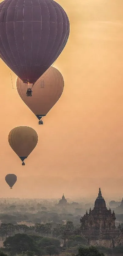 Hot air balloons floating over Bagan at sunset with a misty, serene landscape.