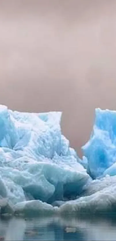 Peaceful iceberg landscape with serene reflections on water under a calm sky.