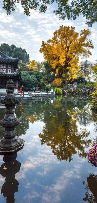 Serene Japanese garden with golden trees and reflective pond.