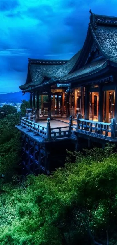 Beautiful Japanese architecture at night with vibrant blue sky.