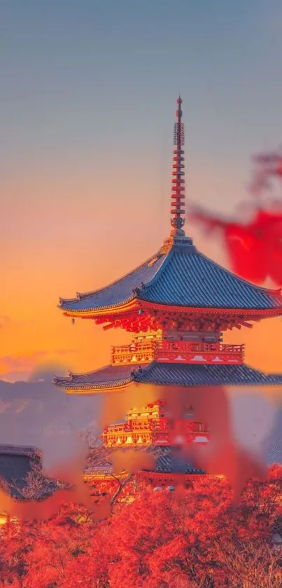 Japanese temple with orange sunset sky in background.