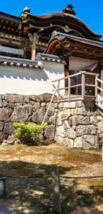 Serene Japanese temple surrounded by nature under a clear blue sky.