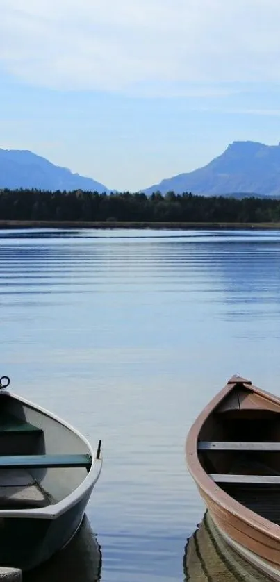 Two boats on a serene lake with mountains in the background.