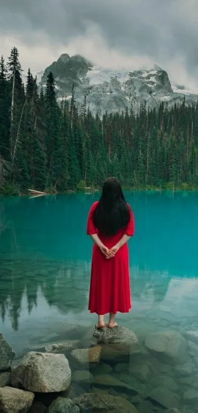 Serene lake with mountains and a person in red dress.