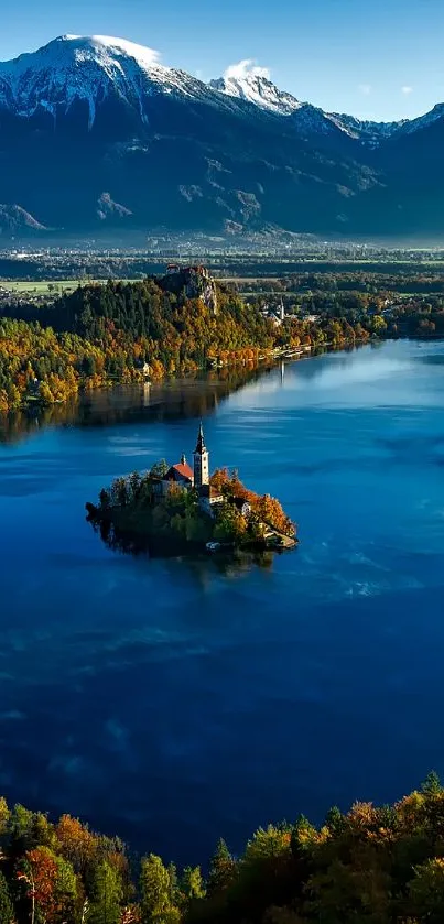 Peaceful lake surrounded by mountains and autumn trees at sunrise.