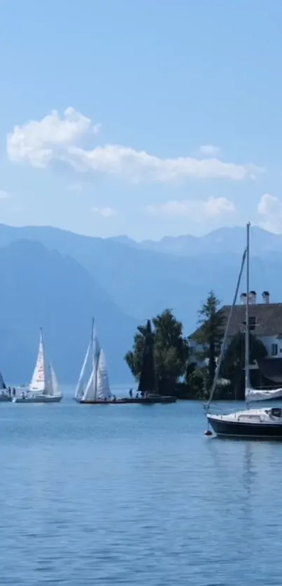 Serene view of sailboats on a lake with mountains.