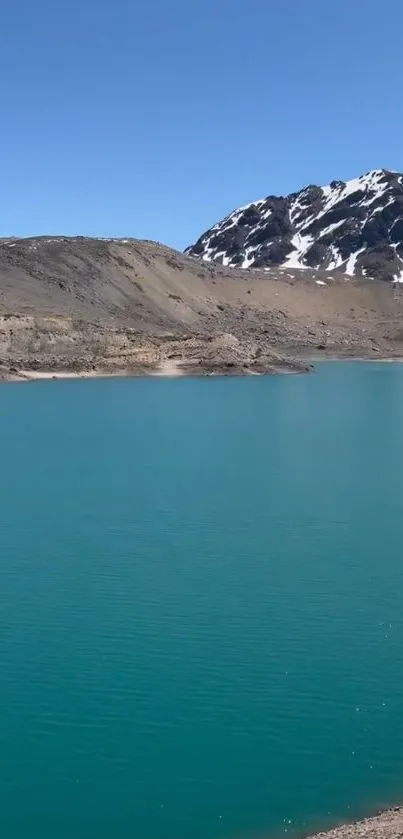 Turquoise lake with snowy mountains backdrop