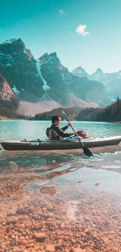 Kayaker on turquoise lake with mountains.