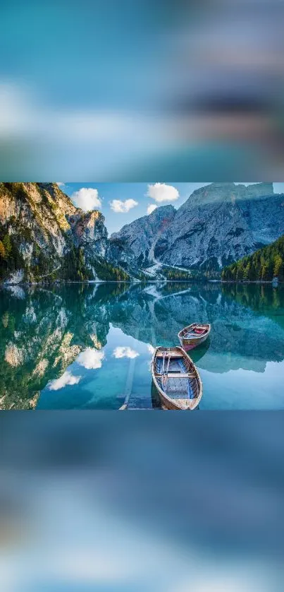 Two boats on a tranquil mountain lake with reflection.