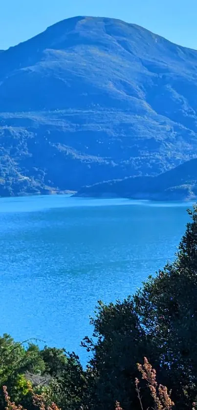 Tranquil lake with mountain view offering a serene nature background.