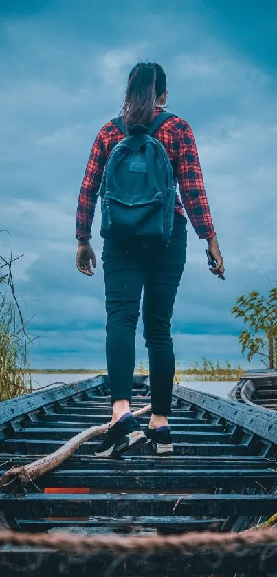 Traveler walking on wooden path under dramatic cloudy sky.