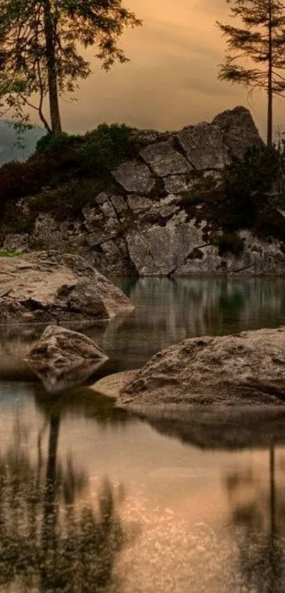 Serene lake with sunset reflecting in calm waters and rocky landscape.