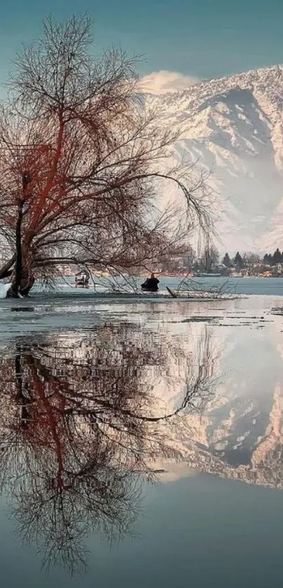 Serene winter lake with mountain reflection.