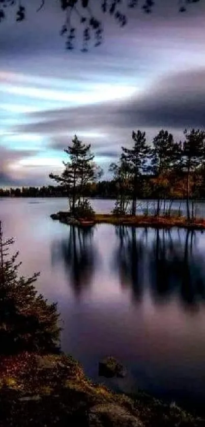 Serene lake at sunset with tree silhouettes and calm water reflections.