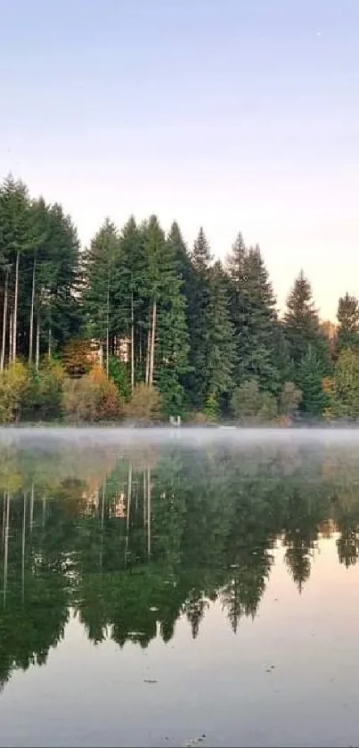 Scenic sunset view over calm lake with trees reflecting in water.