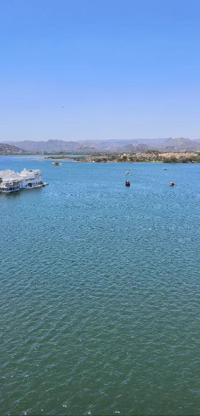 Serene lake with boats and distant hills.