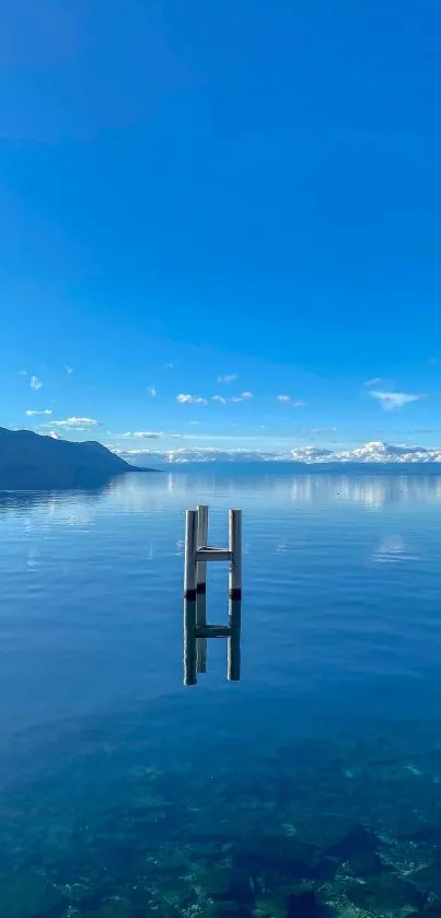 Serene lake view with blue sky and calm water.