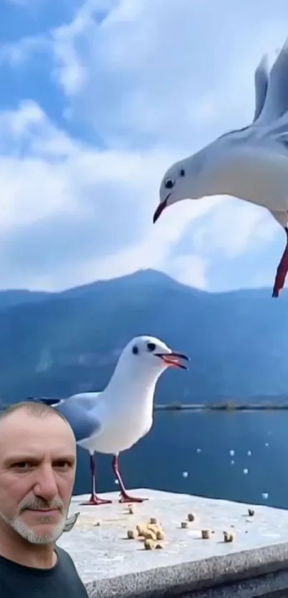 Seagulls flying over a serene lake with mountains in the background.