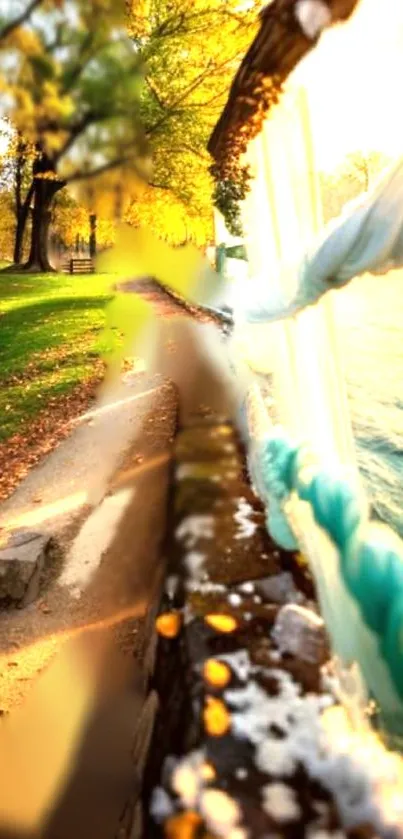 Serene lakeside path with autumn trees and sunlight over water.