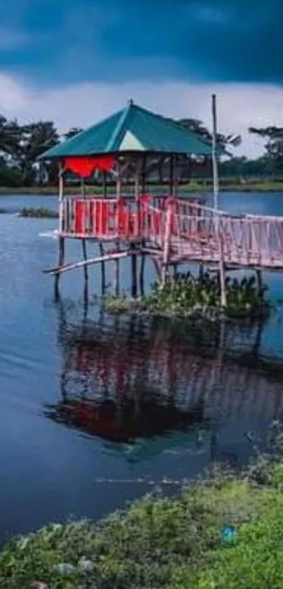 Tranquil lakeside pavilion with cloudy sky and water reflection.