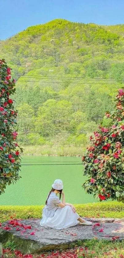 Woman in white dress by a serene lakeside with vibrant flowers and green hills.