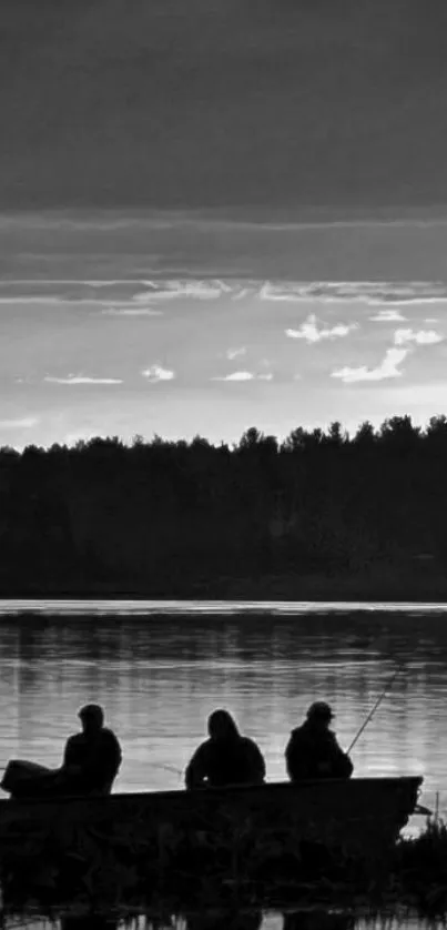 Three silhouetted figures fishing on a tranquil lake at dusk.