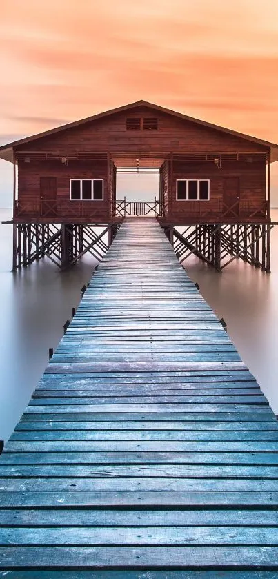 Serene sunset over a lakeside house with a wooden pier.