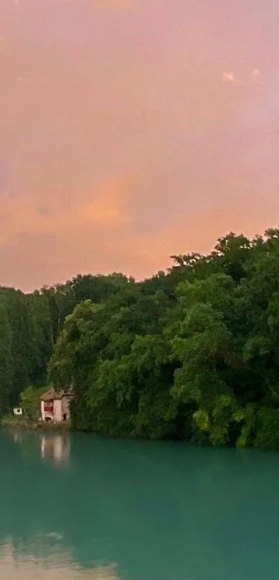 Lakeside view with sunset sky and green trees reflecting on the water.