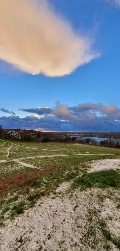 Serene landscape with blue sky and clouds, perfect for mobile wallpaper.