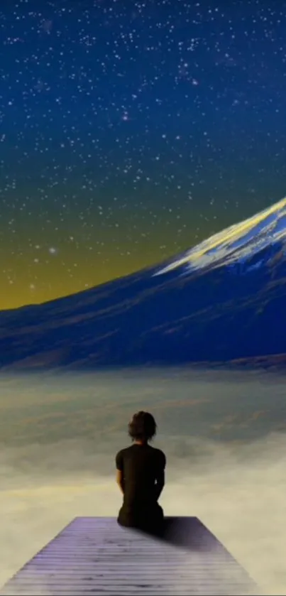 Person sitting under starry sky beside mountain.