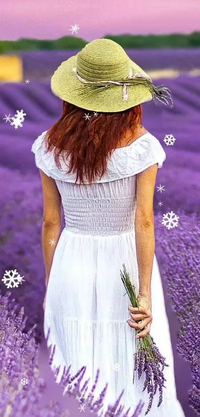 Woman in white dress walking through a lavender field with a pink sky.