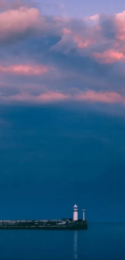 A lighthouse by the ocean at dusk under vibrant colorful skies.