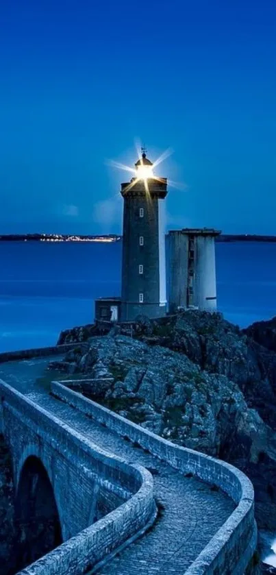 Serene lighthouse with ocean view and starry sky.