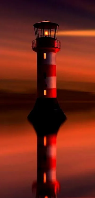 Lighthouse with sunset reflection over calm waters.