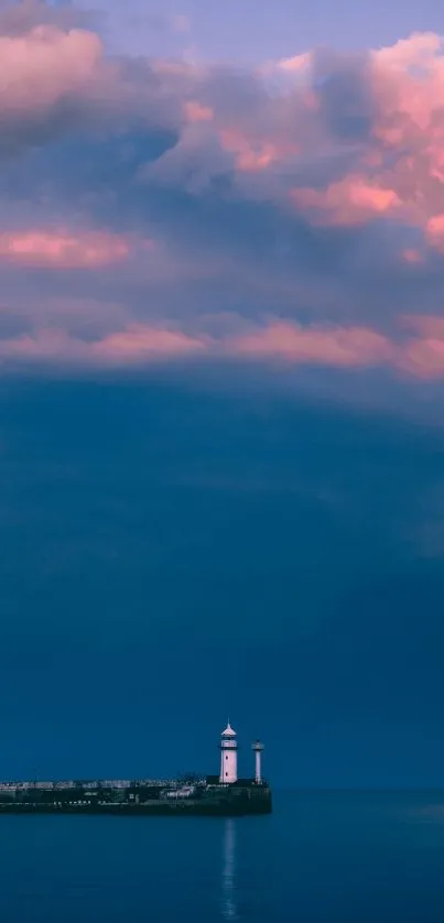 Lighthouse against a vibrant sunset sky with purple and pink clouds over the ocean.