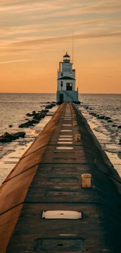 Lighthouse at the end of a pier during a warm, glowing sunset over the ocean.