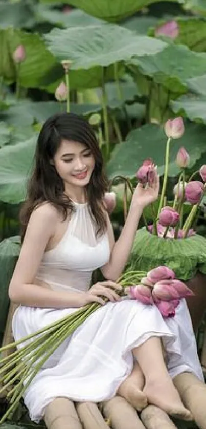 Woman sitting by lotus pond holding flowers, wearing white dress.