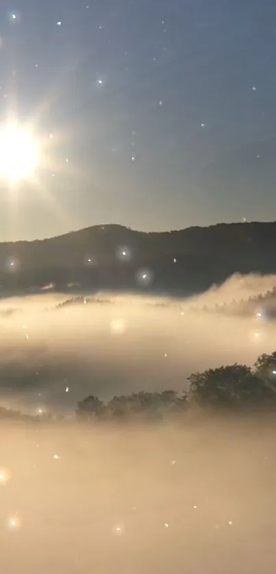 Scenic misty sunrise over mountains with sunlight breaking through fog.