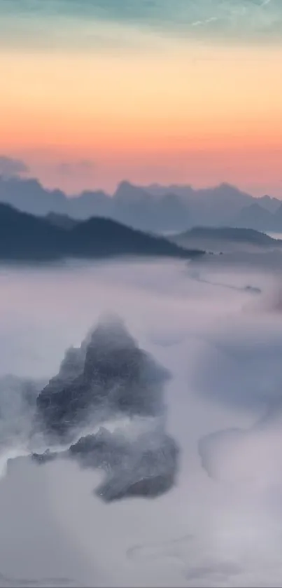 Misty mountain landscape during sunrise with serene clouds.