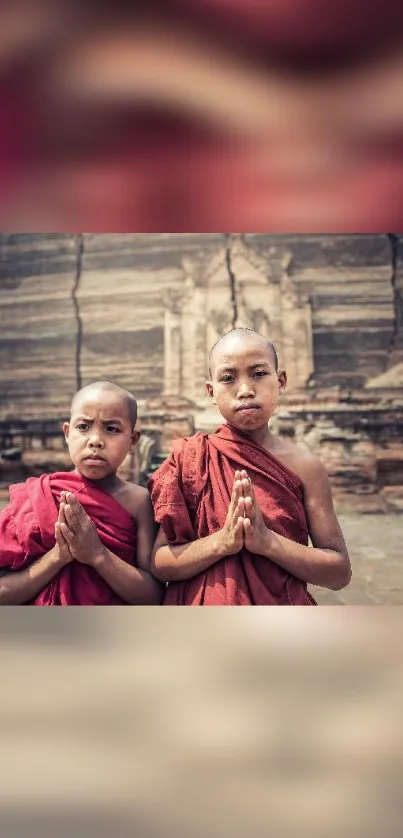 Two young monks praying at an ancient temple.