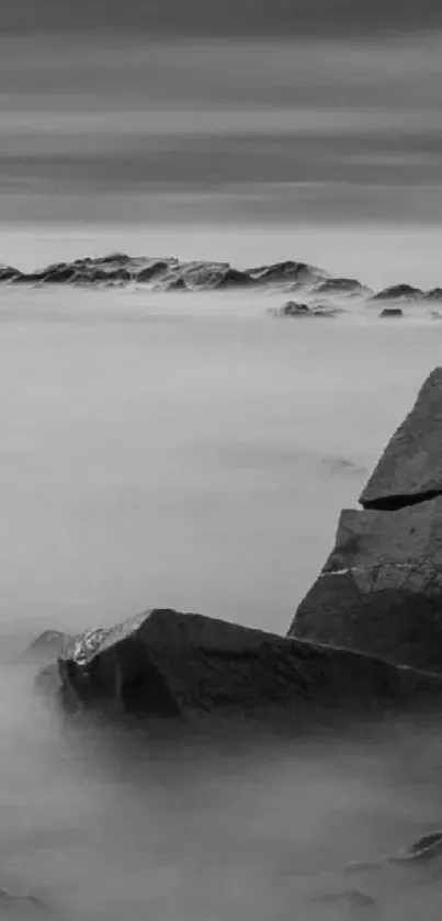 Monochrome wallpaper with serene sea rocks.