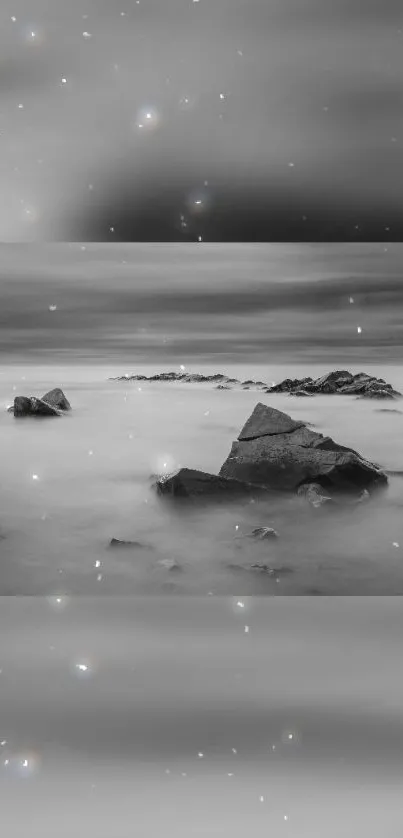 Monochrome seascape with rocks in gentle mist.