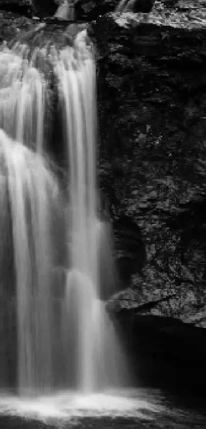 Black and white wallpaper of a serene waterfall cascading over rocky cliffs.