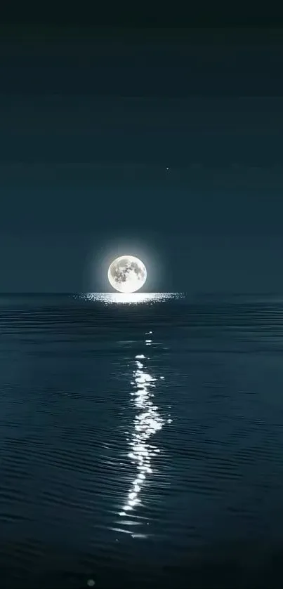 Full moon reflecting over calm ocean waters at night.